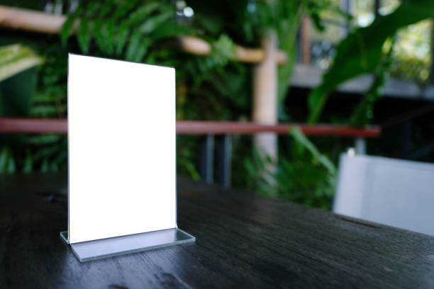 istock Mock up Menu frame standing on wood table in Bar restaurant cafe. space for text 961732850