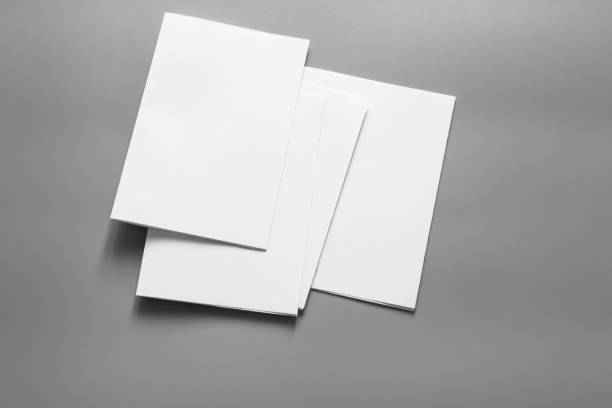 istock Blank portrait mock-up paper. brochure magazine isolated on grey, changeable background / white paper isolated on grey 961732896