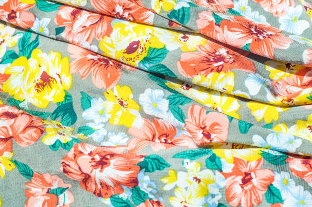 istock Texture, background, pattern. Girl's skirt. Silk fabric with floral pattern. Red Yellow Flowers 961733022