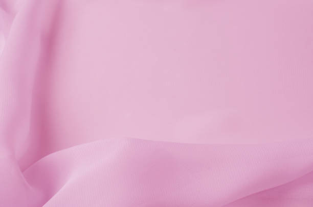 Texture, background, pattern. Silk fabric pale pink, abstract folds