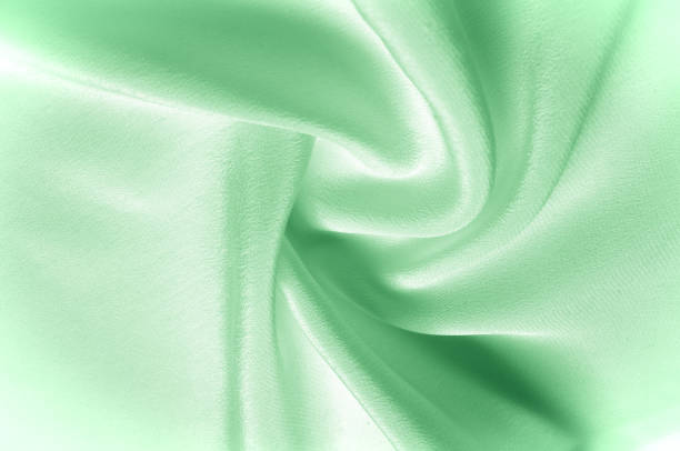 istock Texture background pattern. Green silk fabric. Closeup of a corrugated green silk fabric. Advertising space. Smooth elegant green silk can be used as a wedding background. 961733224
