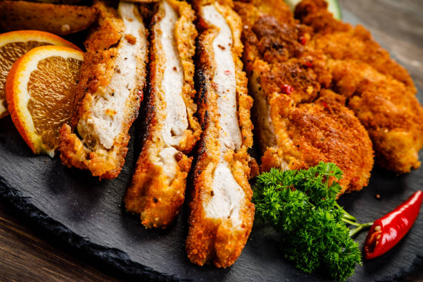 istock Schnitzel, baked potatoes and vegetables 961733370
