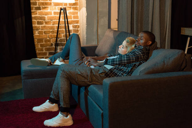 istock multicultural couple sleeping on sofa together at home 961733422