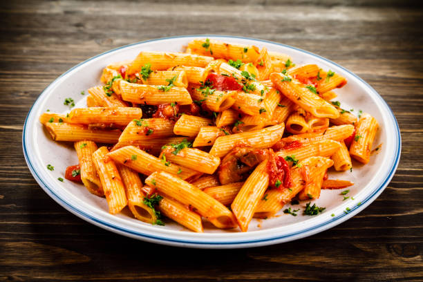 Penne with sauce and pork Pasta with vegetables penne stock pictures, royalty-free photos & images