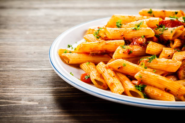 istock Penne with sauce and pork 961735712