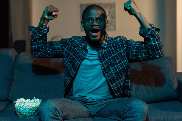 istock african american man watching tv 961736184