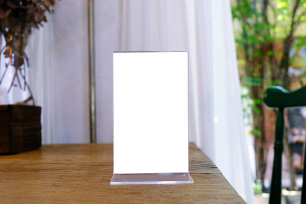 istock Mock up Menu frame standing on wood table in Bar restaurant cafe. space for text 961736844