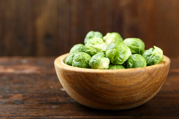 istock raw Brussels sprouts in a plate, space for text. 961736966