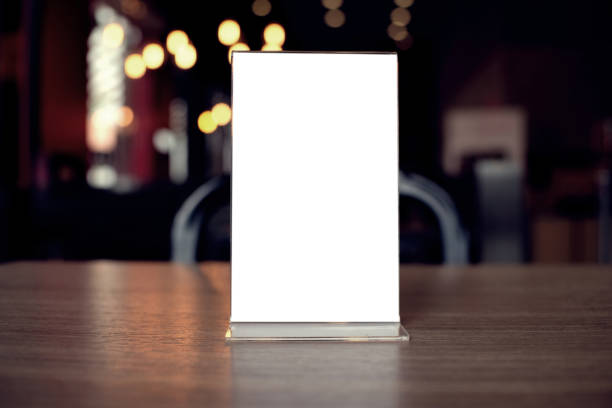istock Mock up Menu frame standing on wood table in Bar restaurant cafe. space for text 961737010