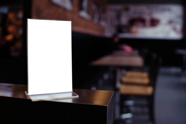 istock Mock up Menu frame standing on wood table in Bar restaurant cafe. space for text 961737024