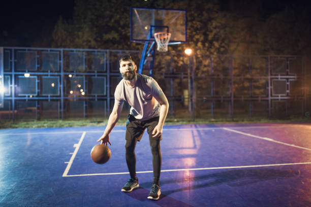 istock Young bearded men playing basketball outdoors 961738418
