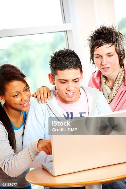 Three Teenage Students Working On Laptop In School Stock Photo - Download Image Now - High School Student, Laptop, Multiracial Group