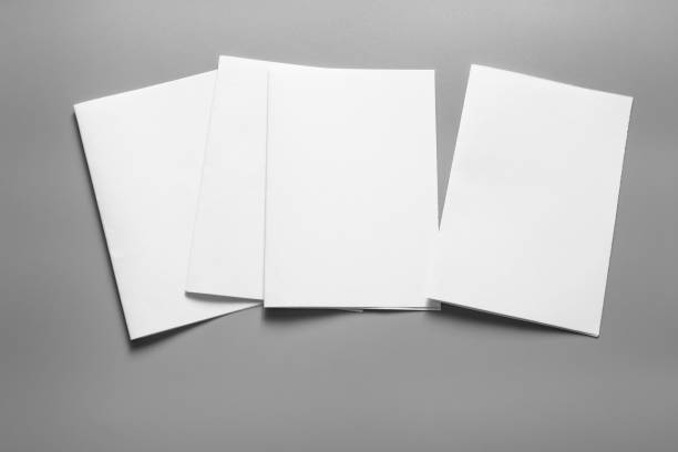 istock Blank portrait mock-up paper. brochure magazine isolated on grey, changeable background / white paper isolated on grey 961745820