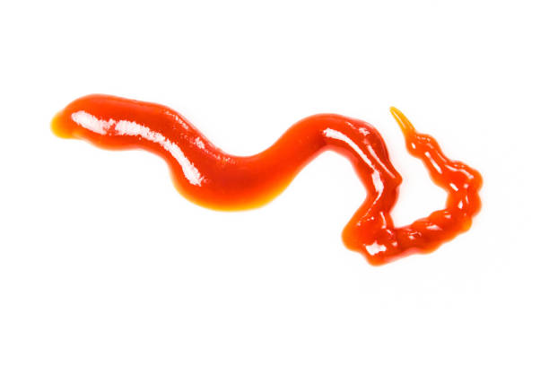 istock Tomato sauce isolated on white background. Red ketchup splashes isolated on white background, top view 961746584