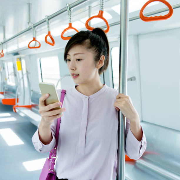 istock Woman using phone in the subway train 961747834