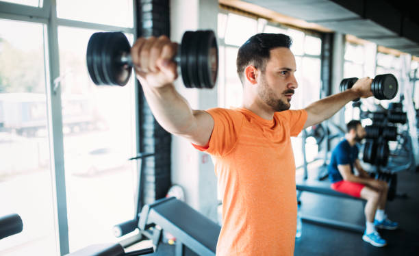 istock Determined male exercising in gym 961749098
