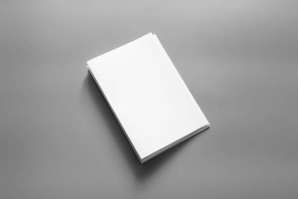 istock Blank portrait mock-up paper. brochure magazine isolated on grey, changeable background / white paper isolated on grey 961750056