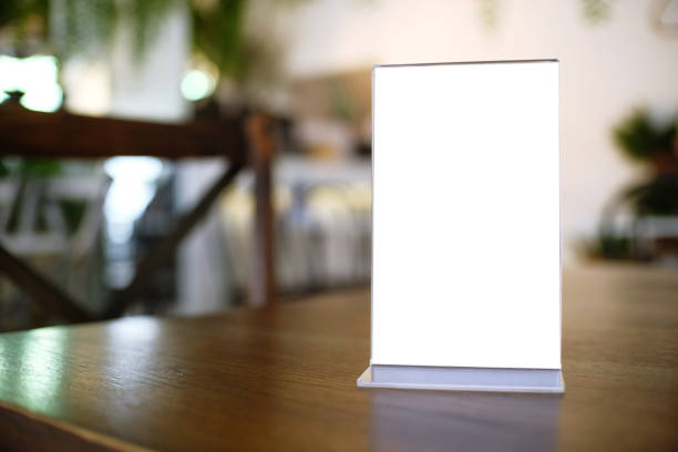 istock Menu frame standing on wood table in Bar restaurant cafe. space for text marketing promotion 961751544