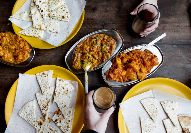 Aerial view of couple enjoying Rajasthani cuisine Aerial view of couple enjoying Rajasthani cuisine masala stock pictures, royalty-free photos & images