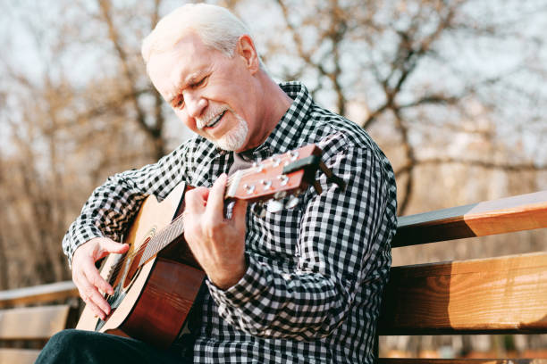 istock Inspired mature man trying guitar play 961752066