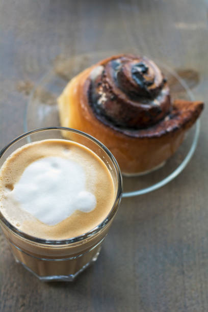 istock One cup of cappuccino with cinnamon rolls 961752286