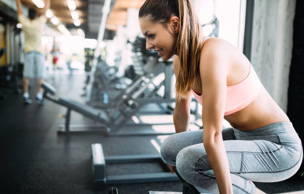istock Young beautiful woman doing exercises in gym 961752298