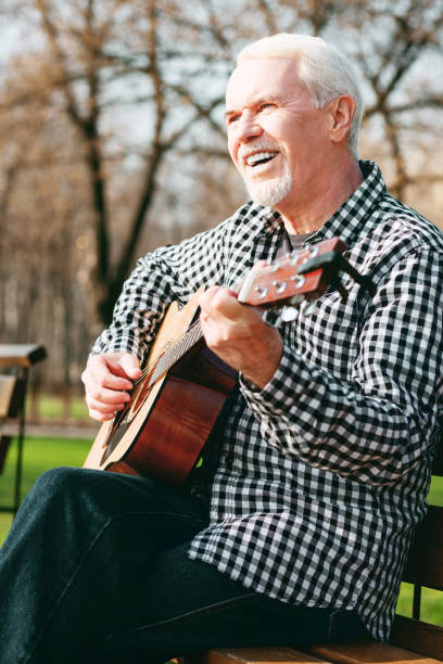 istock Positive mature man studying guitar play 961752528