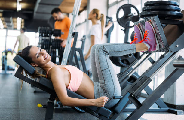 istock Young beautiful woman doing exercises in gym 961753344