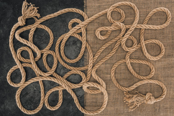 istock flat lay with brown marine ropes with knots on sackcloth and dark concrete surface 961754034