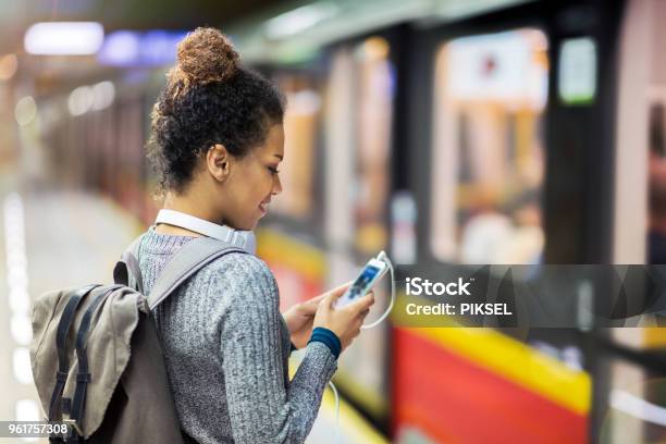 Young Woman Using Mobile Phone On Subway Stock Photo - Download Image Now - 20-29 Years, Adult, Adults Only