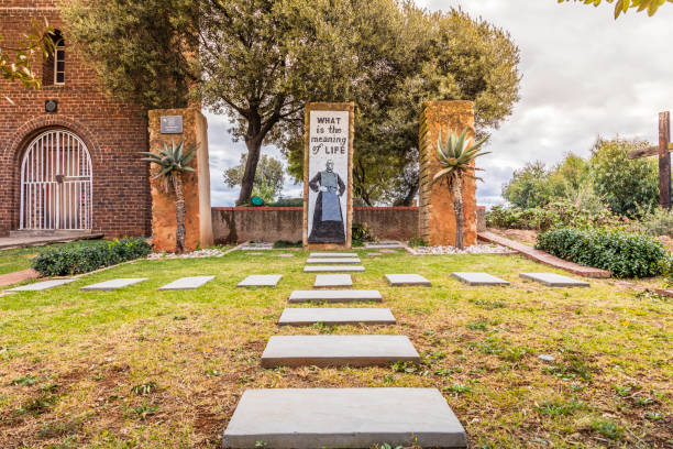 Christ the King Anglican church, Sophiatown parish Garden of rememberance at Trevor Huddlestone anglican church in Sophiatown, where he served during the forced removals in Sophiatown when the Group Areas Act came into legislation in 1950, South Africa. People seen going on a guided excursion. apartheid sign stock pictures, royalty-free photos & images