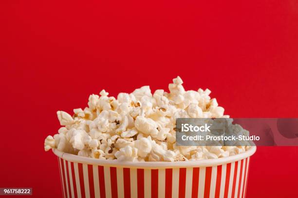 Bucket Of Popcorn On Red Background Stock Photo - Download Image Now - Popcorn, Movie, Bucket