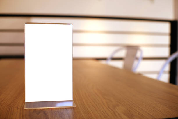 istock Mock up Menu frame standing on wood table in Bar restaurant cafe. space for text 961758452