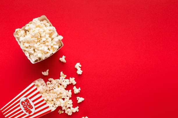 istock Bucket of popcorn on red background, top view 961758796