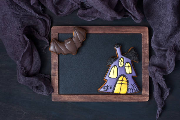 istock Fresh halloween gingerbread cookies on dark  wooden table 961760788