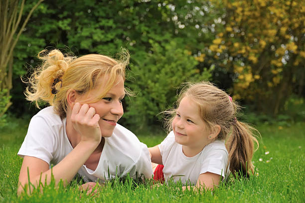 istock Young mother and dauhter laying on the grass 96176929