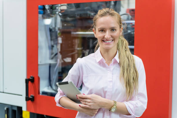 istock Woman working in production line & smiling 961772774