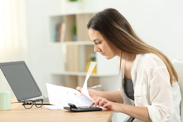 istock Woman calculating expenses at home 961773190