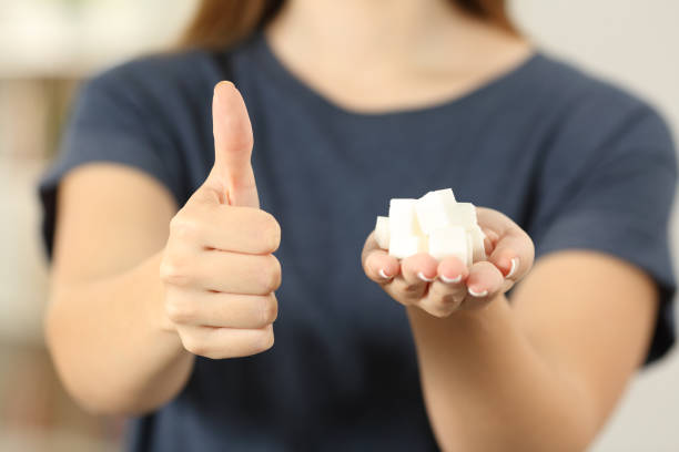 istock Woman hand holding sugar cubes with thumbs up 961773316