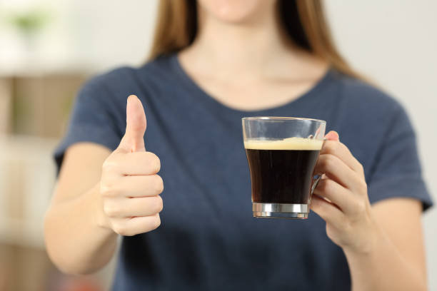 istock Woman hands holding a coffee cup with thumbs up 961773456