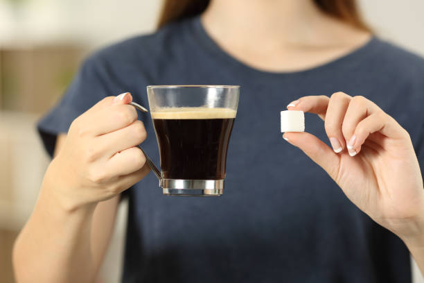 istock Woman hands holding coffee cup and a sugar cube 961773814
