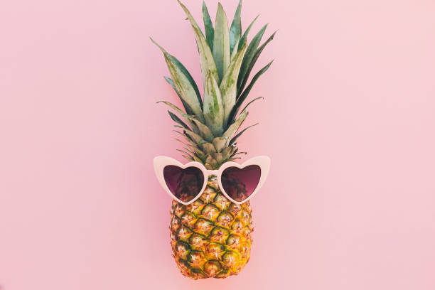 istock stylish pineapple in pink sunglasses on trendy pink paper background. flat lay. summer vacation and party concept. space for text. hipster summer travel and holidays 961774708