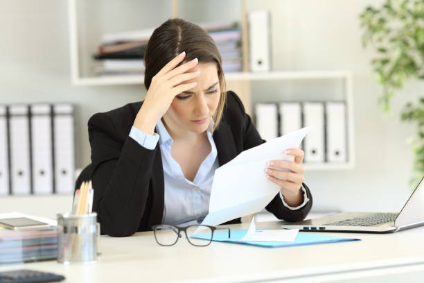 istock Worried executive reading a letter at office 961775028