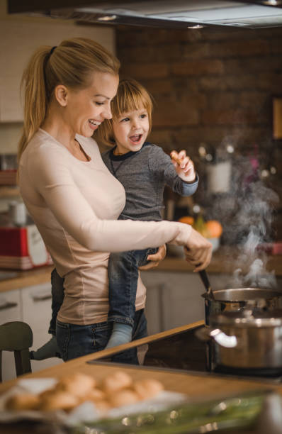 istock Loving mother and son cooking lunch in the kitchen. 961783172