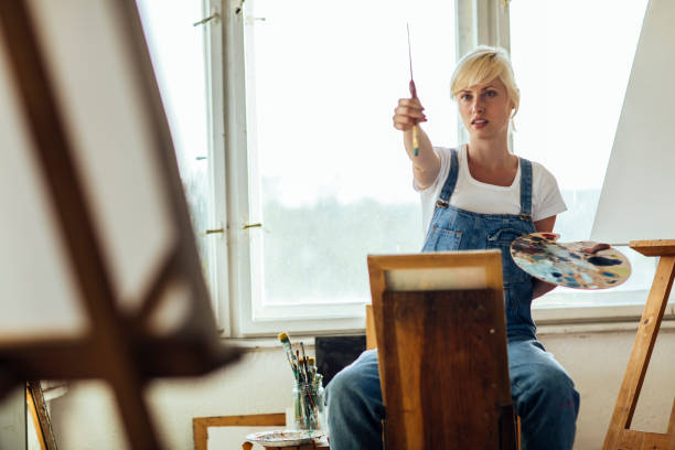 istock Young woman painting 961784926