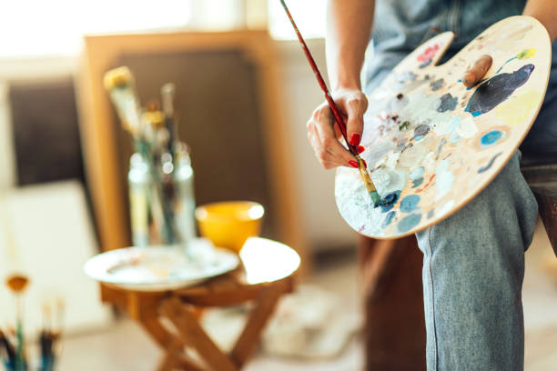 istock The artists hands mixing  paints on a palette 961784928
