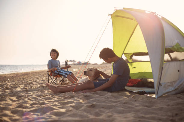 istock The boy's is camping on the beach 961790808