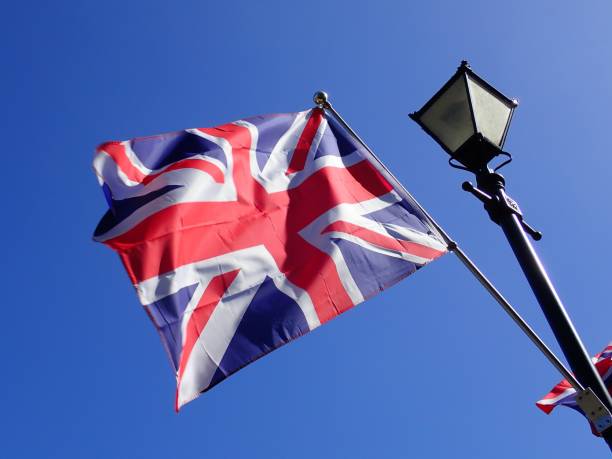 istock Union Jack flag flying from Victorian style lamp post 961793514