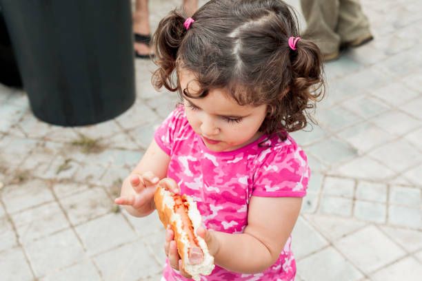 istock High angle kid holding a hot dog 961793882