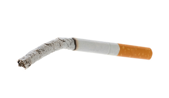 Close-up of a smoked cigarette with shallow depth of field.